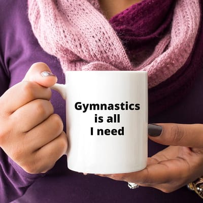 Gymnastics Is All I Need_11oz white mug woman purple shirt holding_800x800