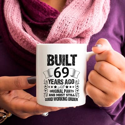 69-Built_11oz white mug woman purple shirt holding_RIGHT-SQ CROP-800